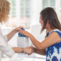 faculty shaking hands and receiving her bag